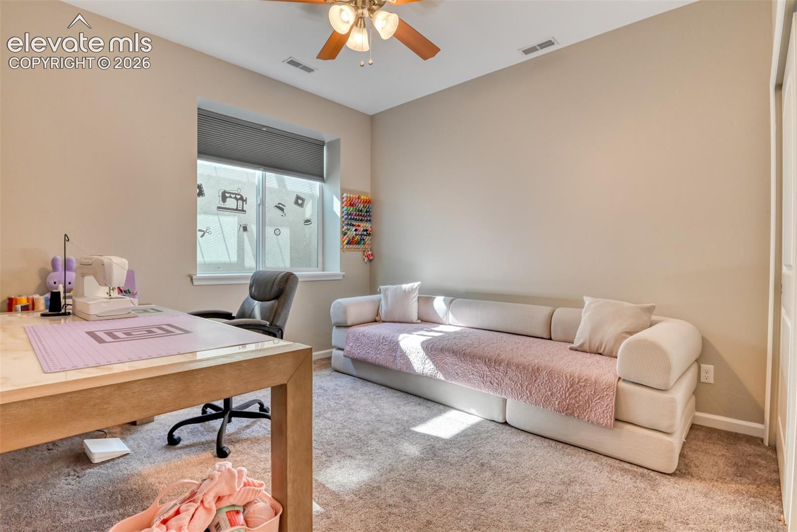 Recessed window with a roller shade, light-colored walls, and a ceiling fan with integrated lighting