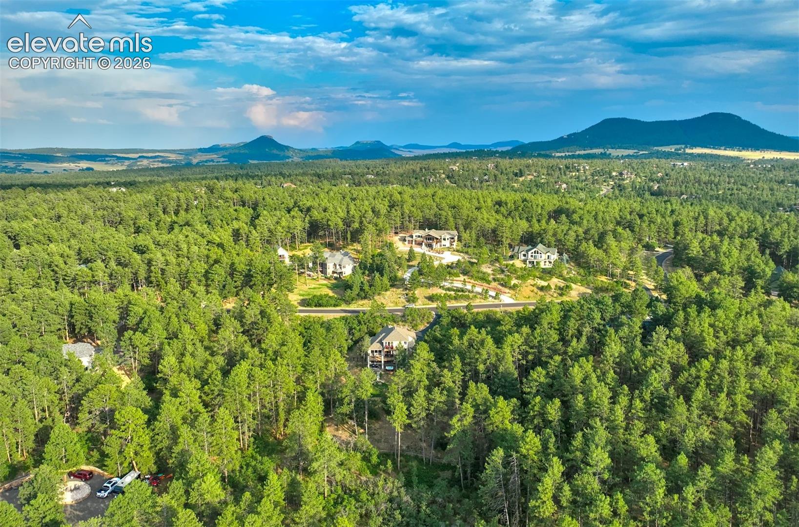Expansive forested setting with distant mountain features