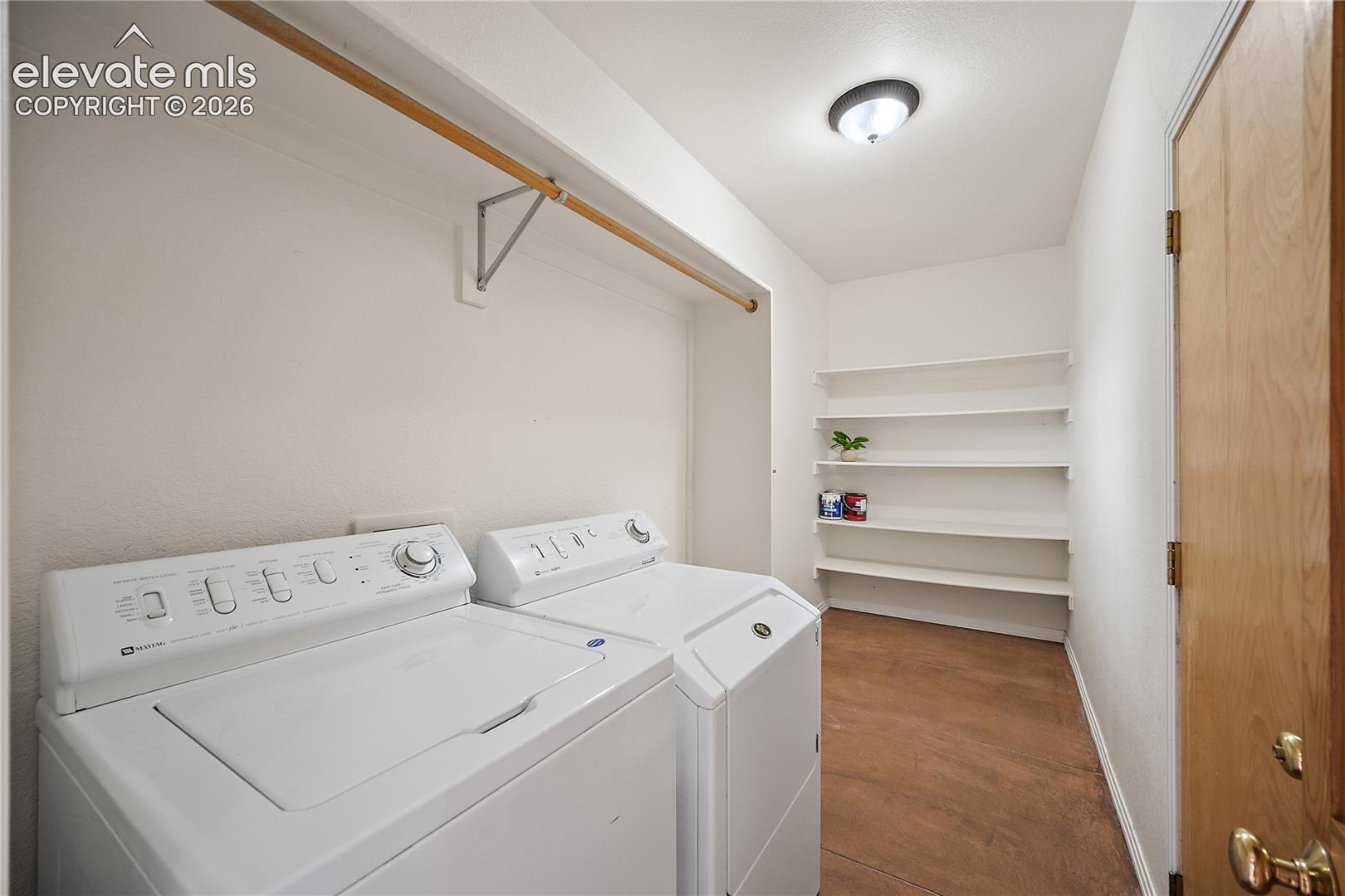 Main level laundry with additional storage space. 