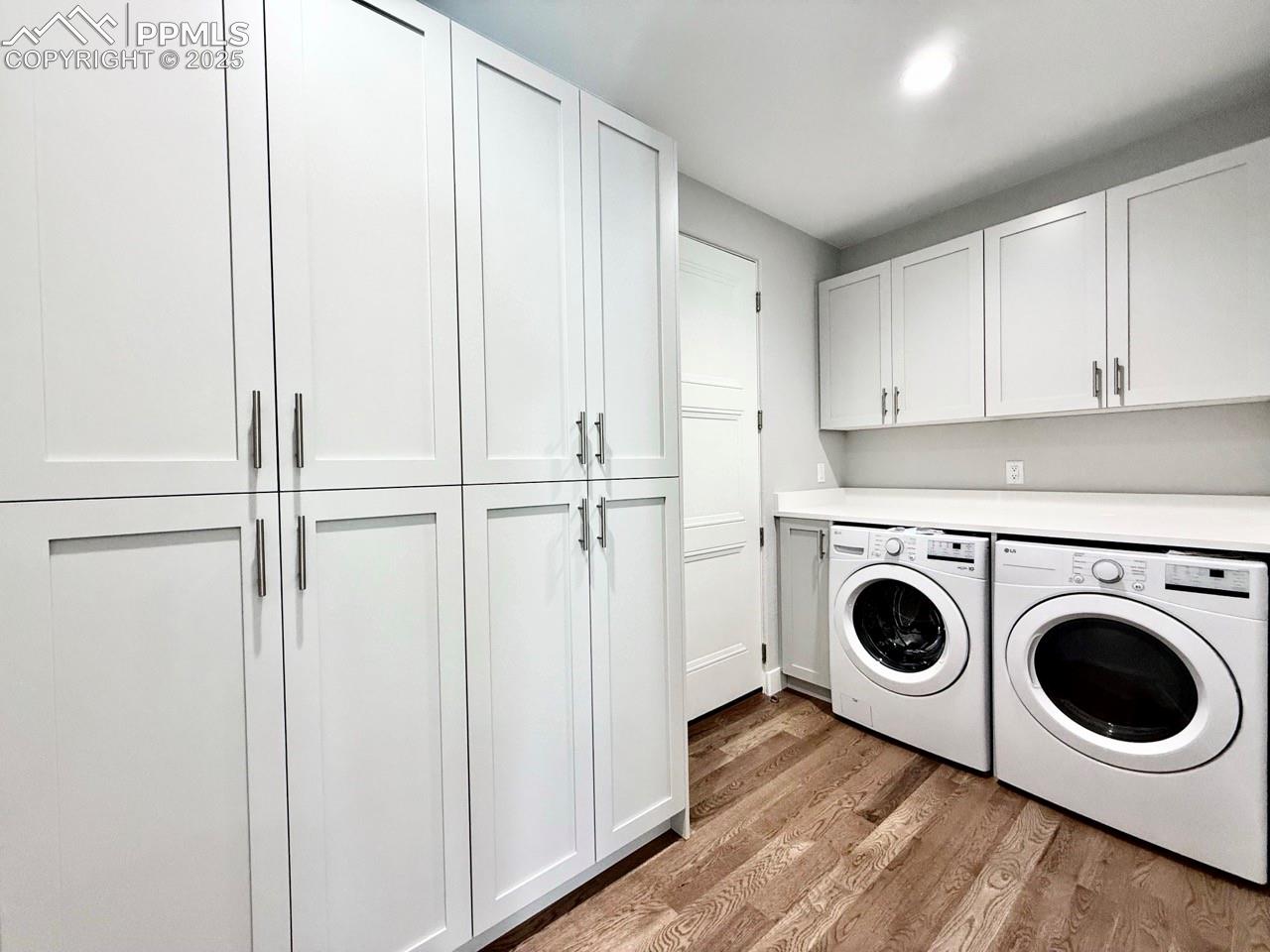 Laundry Room & Pantry with Wood Flooring.
