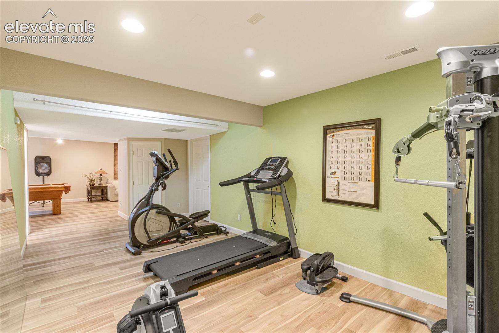 Open-concept interior featuring wood-finish flooring and recessed lighting