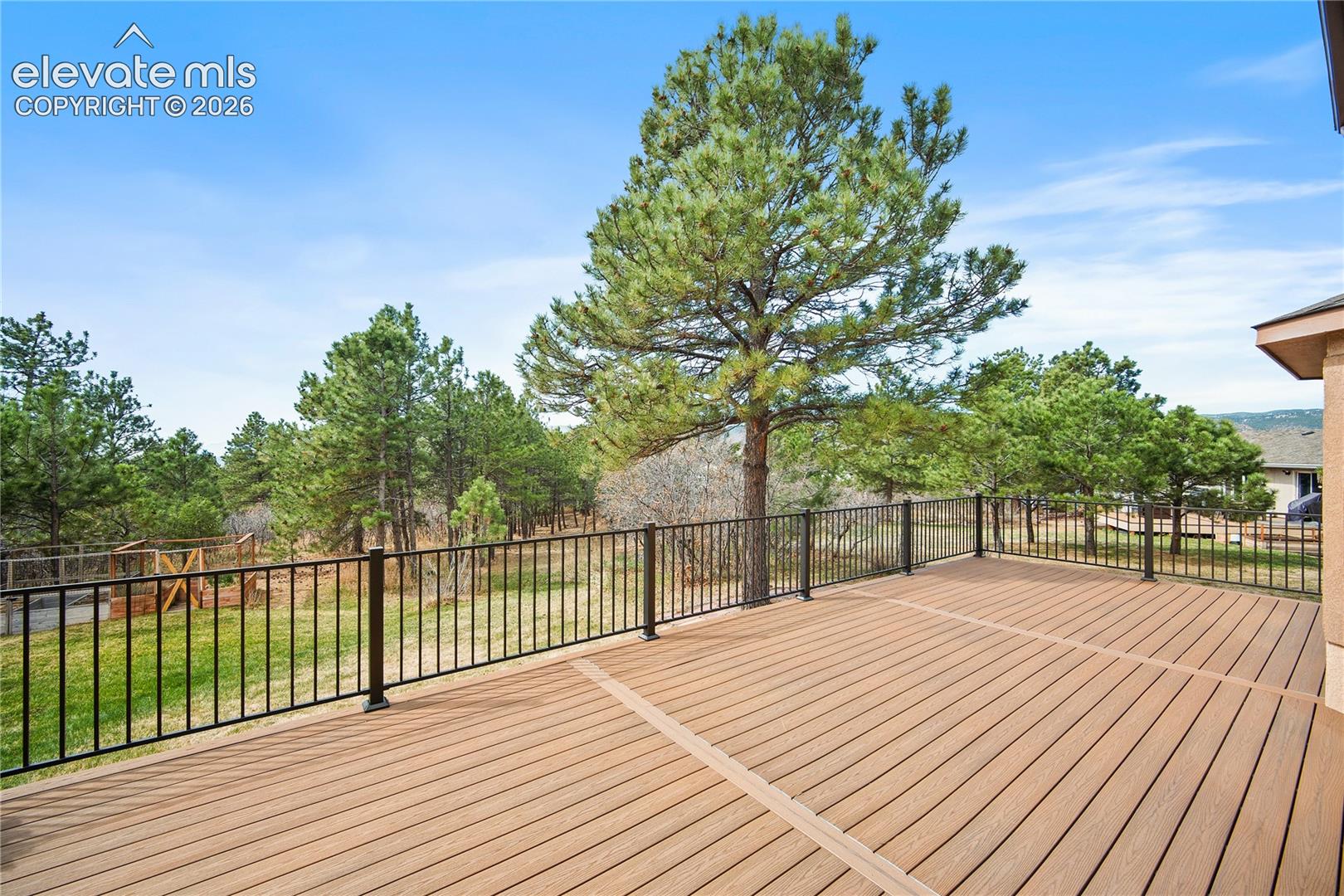 Large deck overlooks back yard