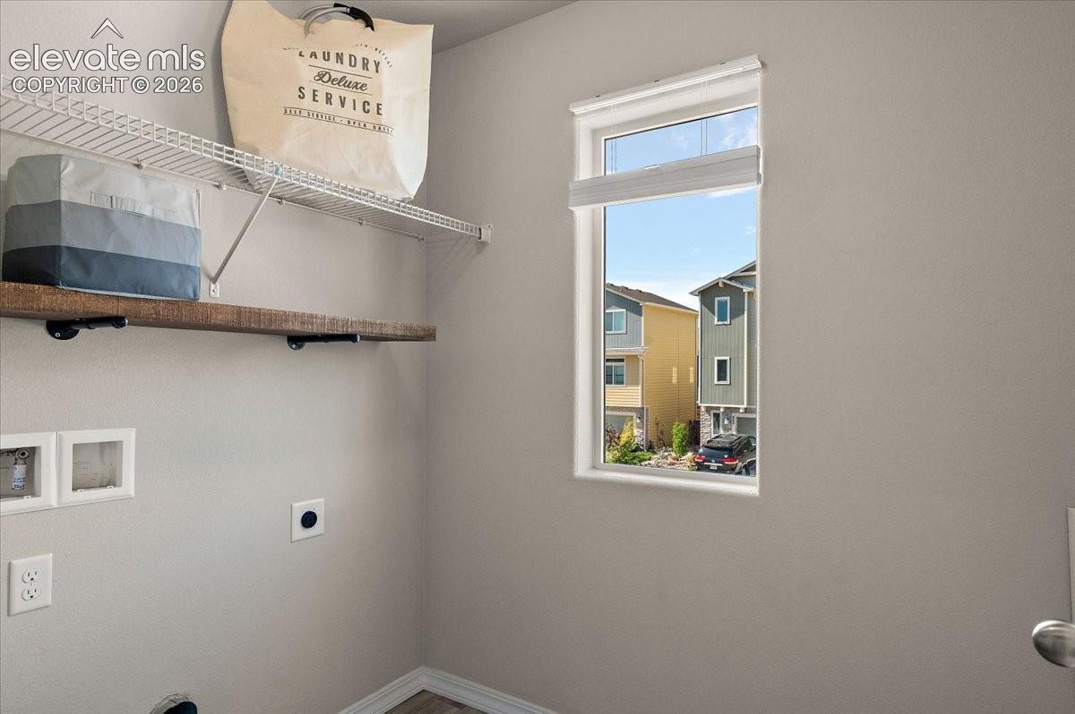 Single window, wood-finish flooring, and light gray wall paint