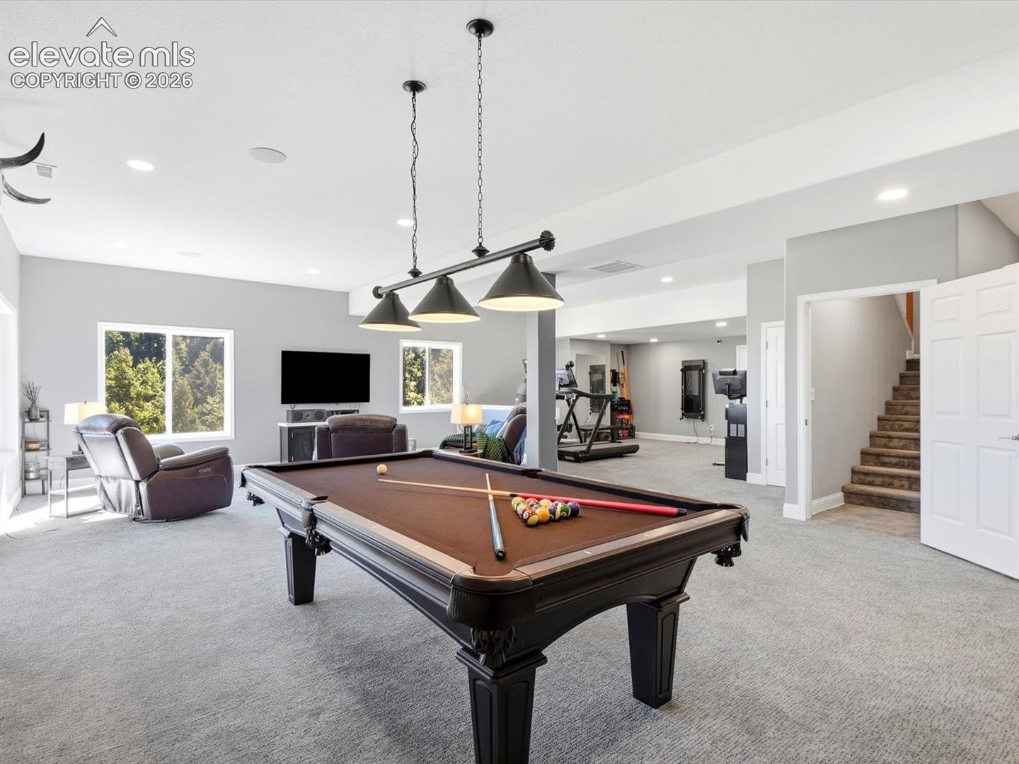 Walk out Open-concept area featuring recessed lighting, multi-bulb pendant fixture, wall-to-wall carpeting, and multiple windows