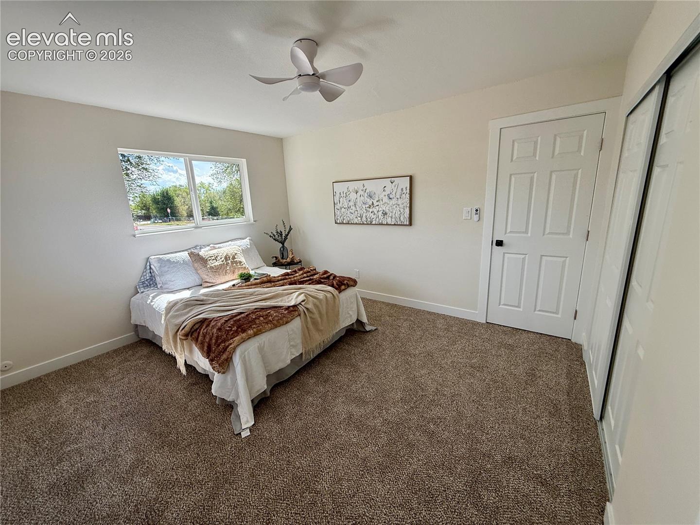 Primary bedroom with new paint and carpet