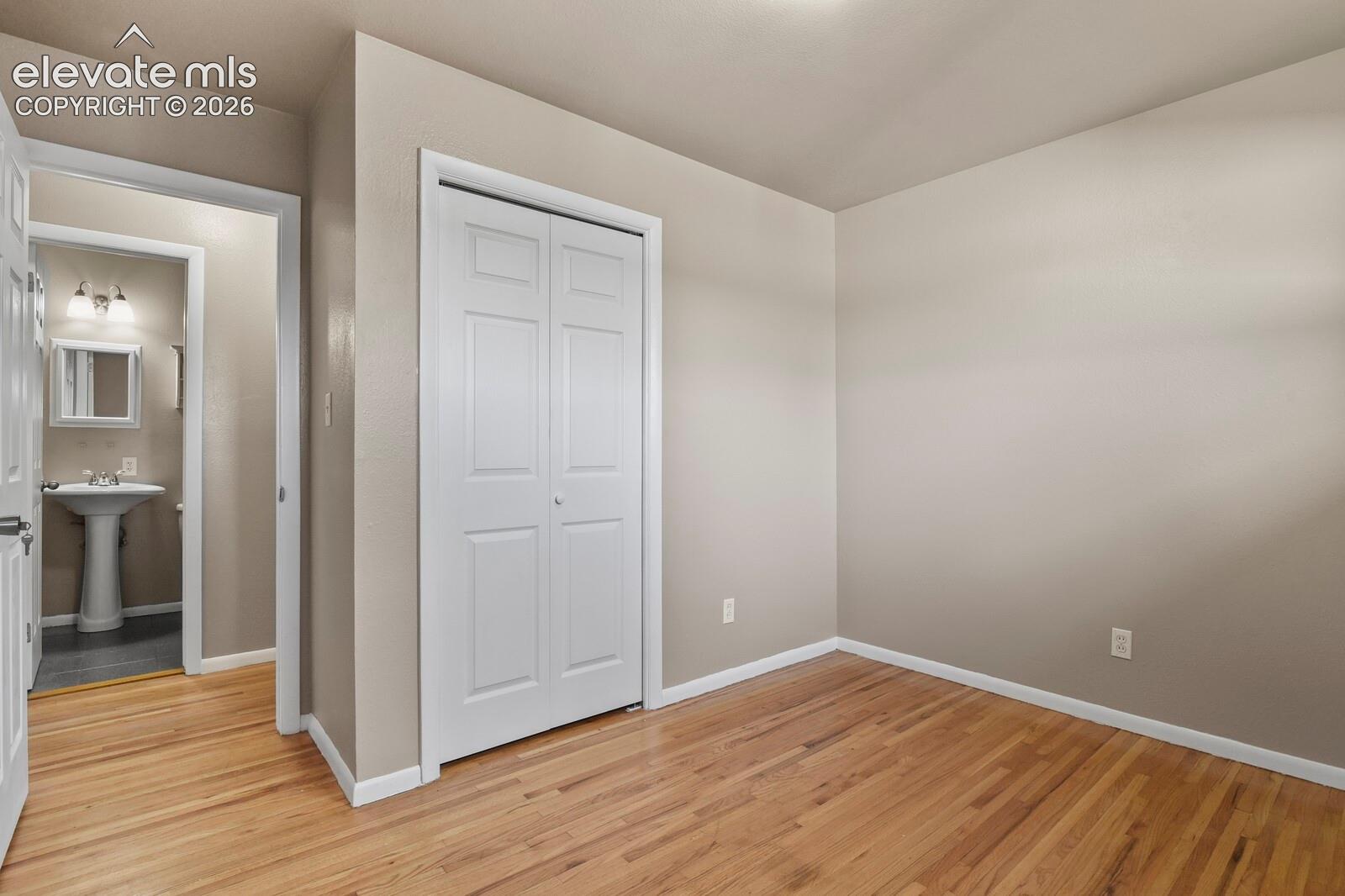 3rd bedroom with hardwood flooring