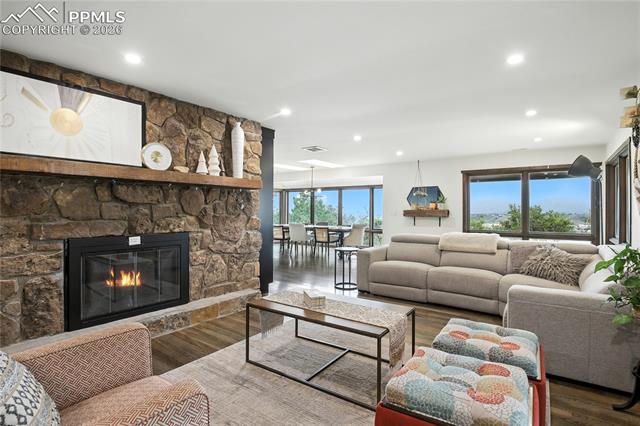 Living area with a fireplace, wood finished floors, and recessed lighting