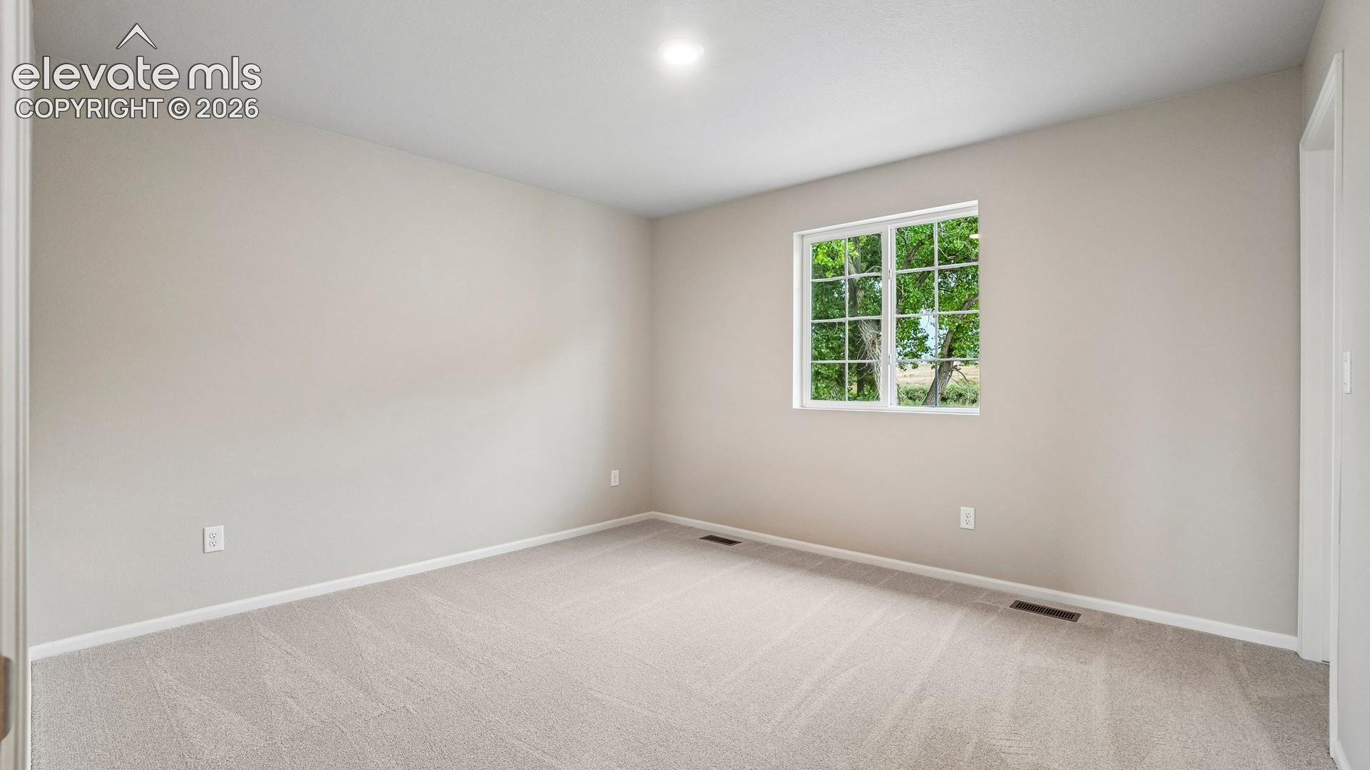 Neutral wall color, recessed ceiling lighting, light-toned carpeting, and a multi-pane window
*photos of a model home*