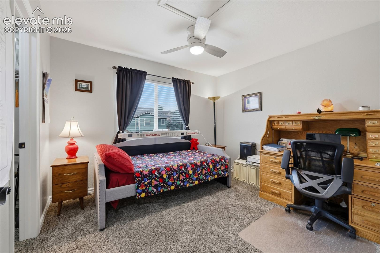 Bedroom #3. Carpet, window with blinds, ceiling fan with integrated lighting, and neutral wall paint