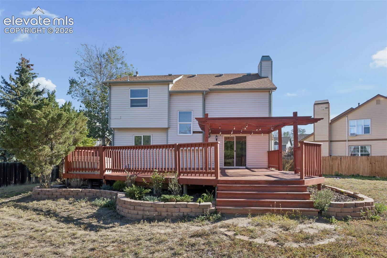 Expansive wooden deck with a built-in pergola