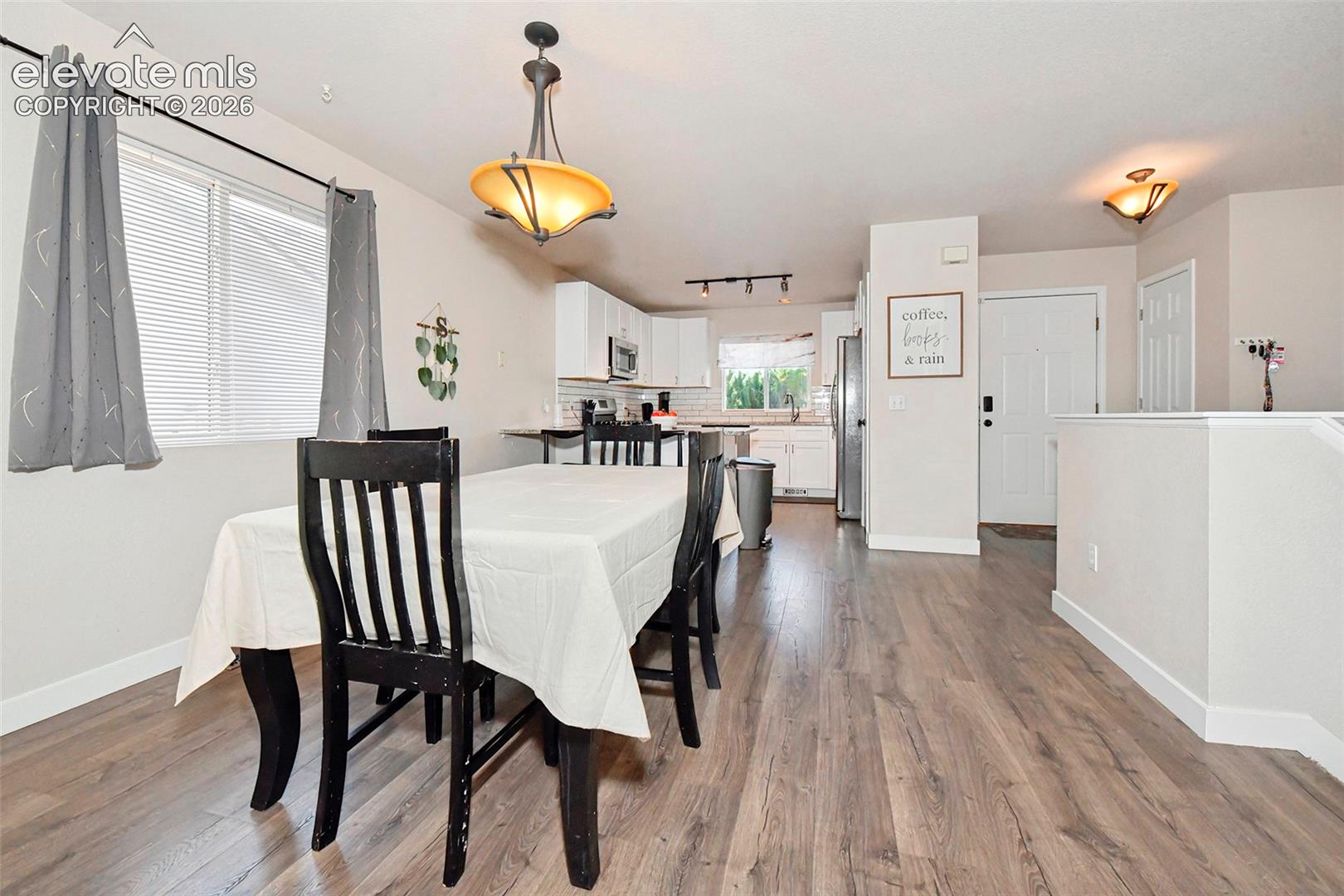 Dining area with view of kitchen, front door and closet.