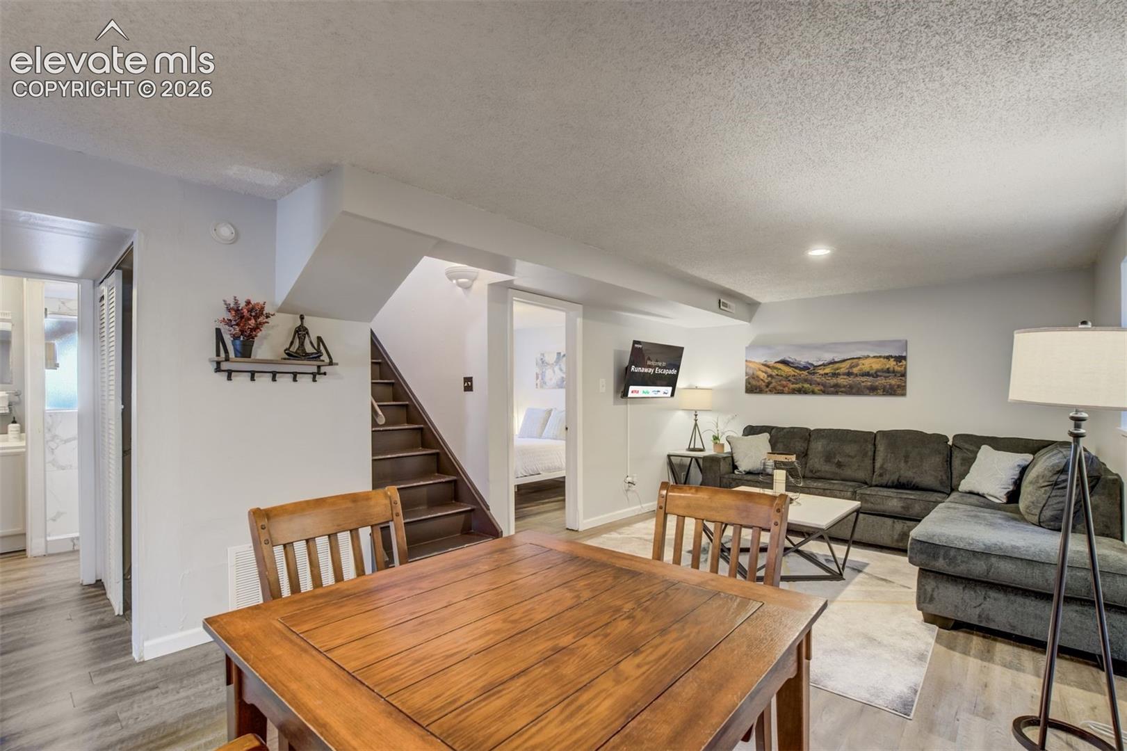 Wood-finish flooring, recessed lighting, and a built-in staircase