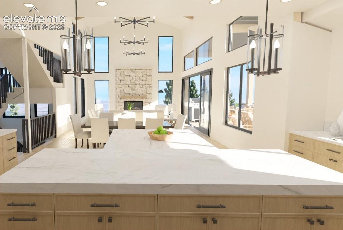 Expansive kitchen island with a light-toned countertop, light wood-finish cabinetry, and dark hardware