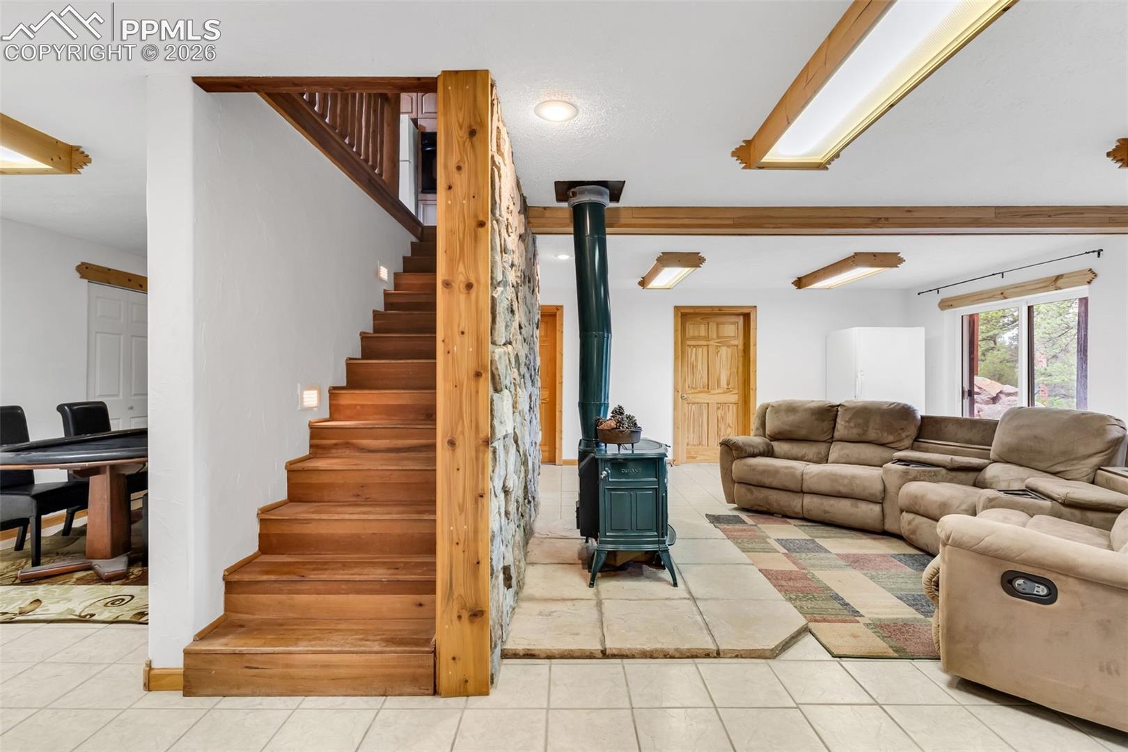 The stairs separate the lower level game area (with tons of closet space) and the den / family room