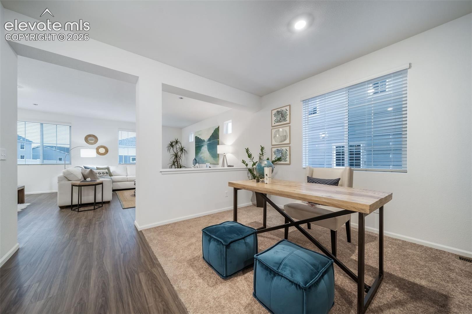 Recessed lighting, large window with blinds, carpeted flooring, and a half-wall partition
*photos of a model home*