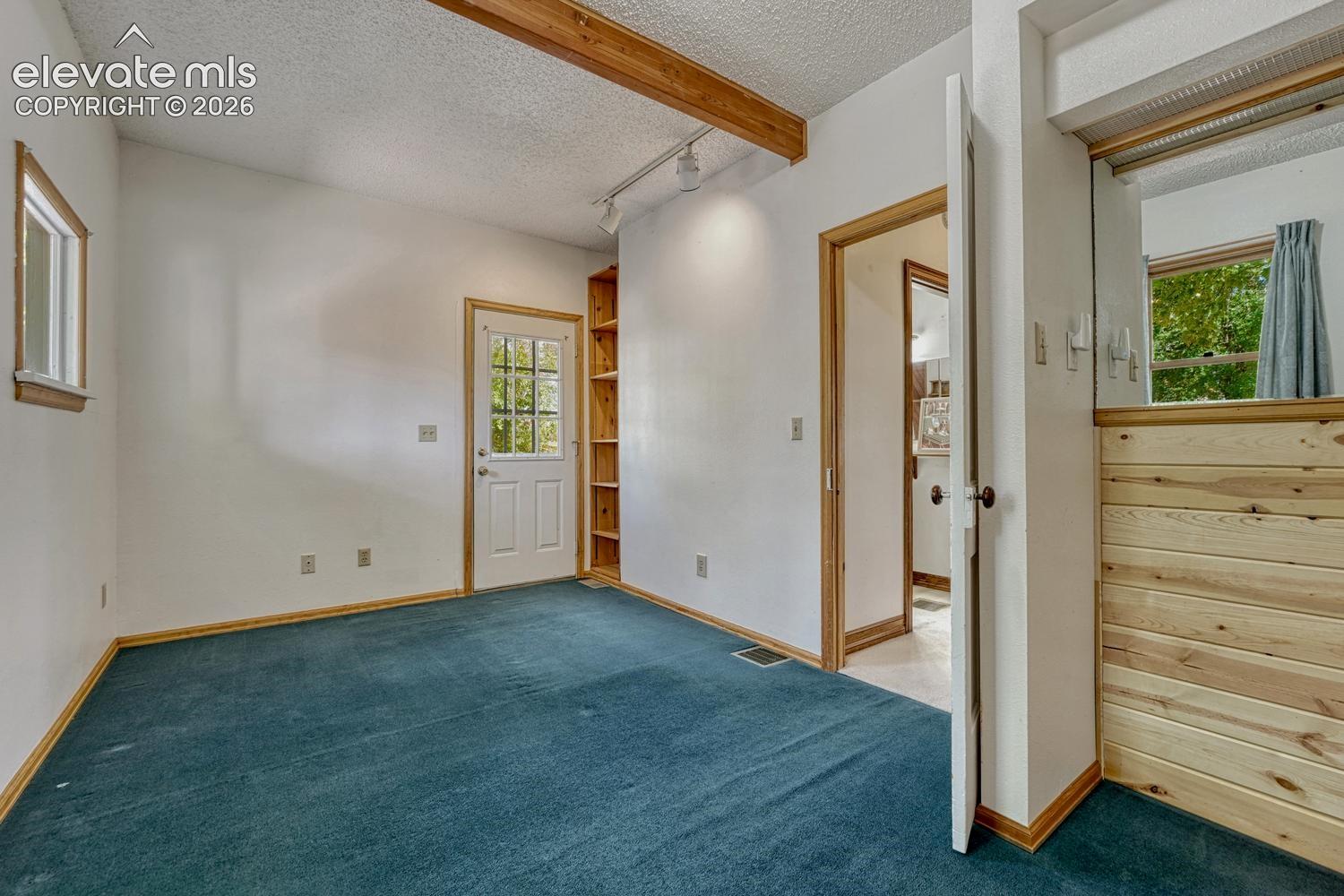 Exposed wood beam ceiling with track lighting