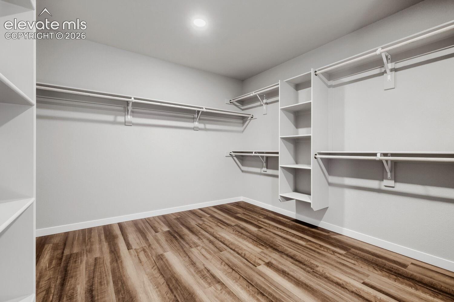 Primary bedroom walk in closet