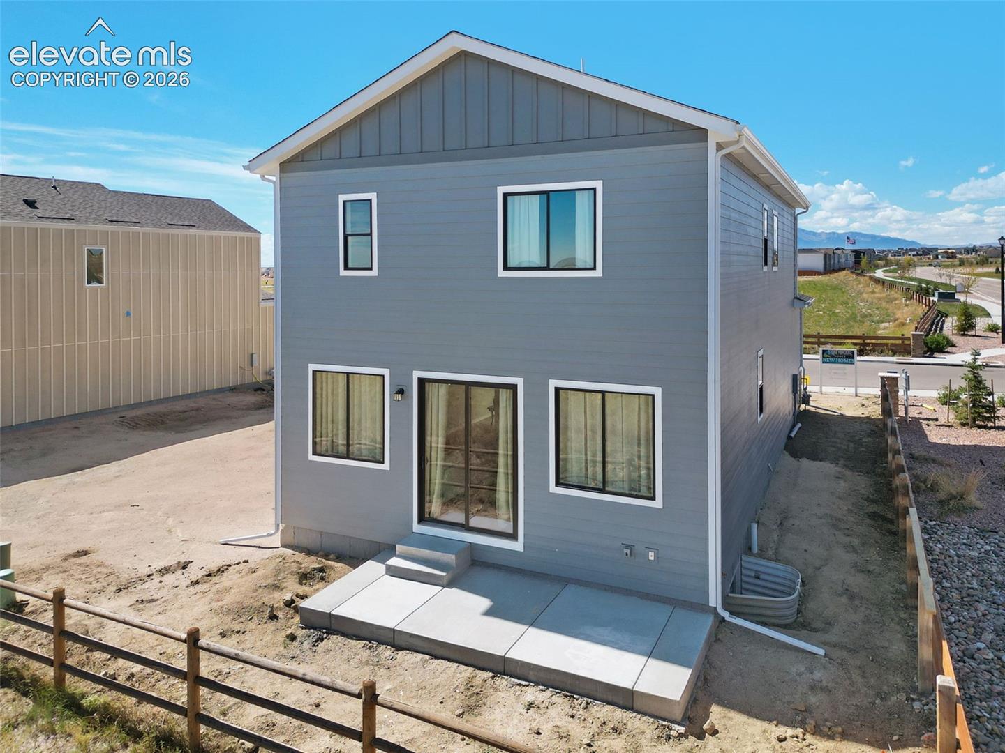 Two-story exterior with horizontal siding and board-and-batten accents
