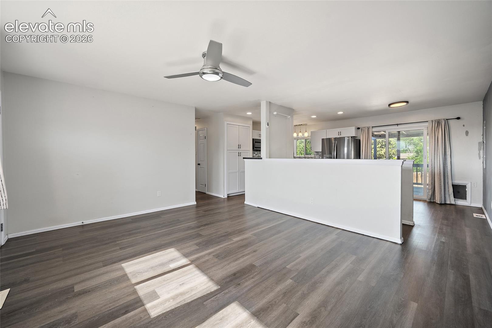 Spacious living room with ceiling fan.