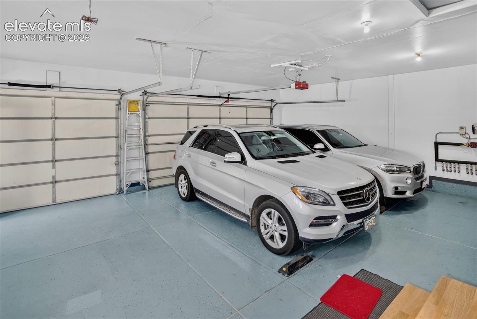 Oversized garage with fresh epoxy coat on floor.
