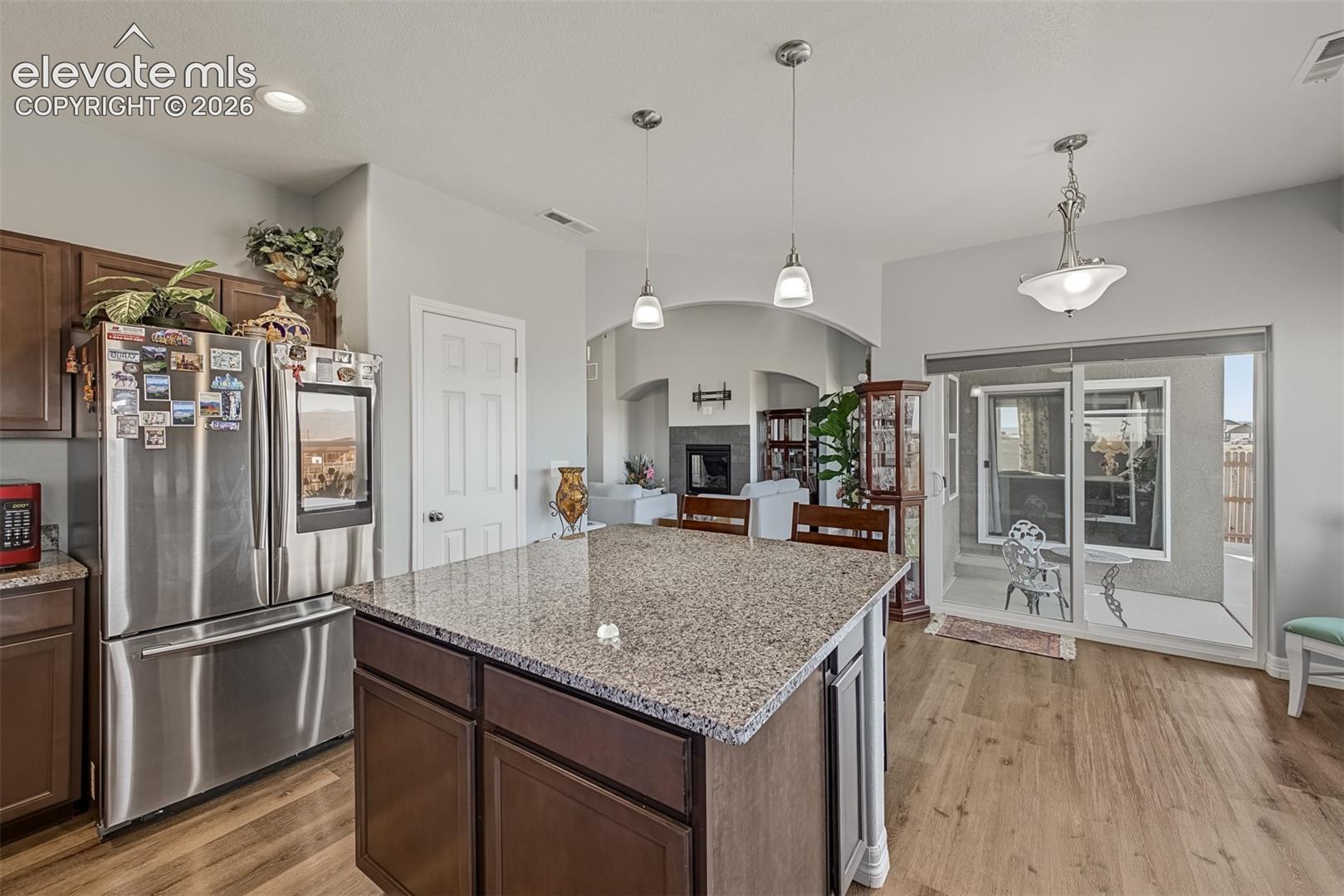 Kitchen is adjacent to the dining nook with bay window and a slider to the covered patio. 