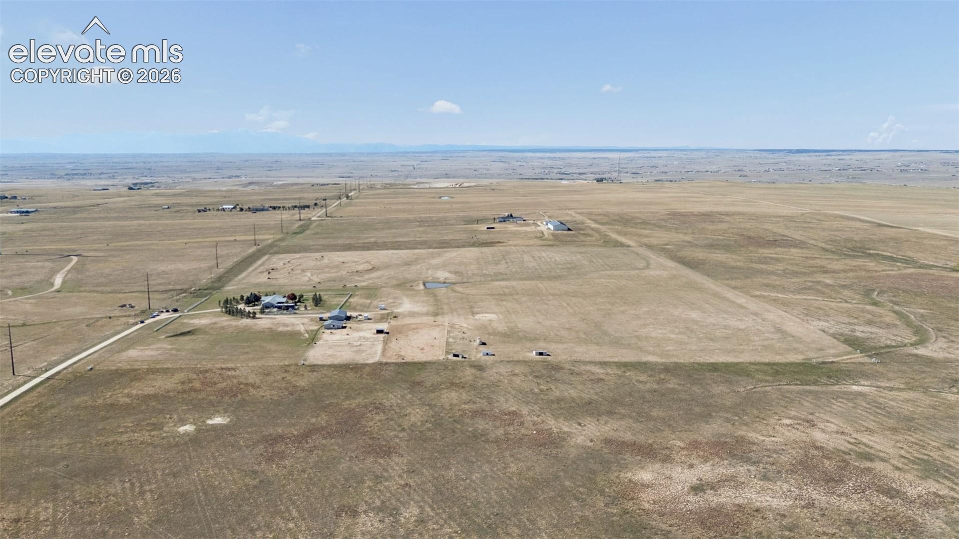 Expansive acreage featuring open topography, level terrain, and mountain horizon backdrops