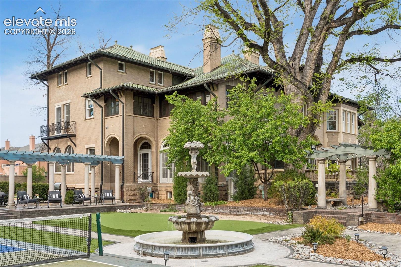 Estate has private pickleball court, putting green, Broadmoor fountain, firepit, reflection pool, veranda, built-in grill
