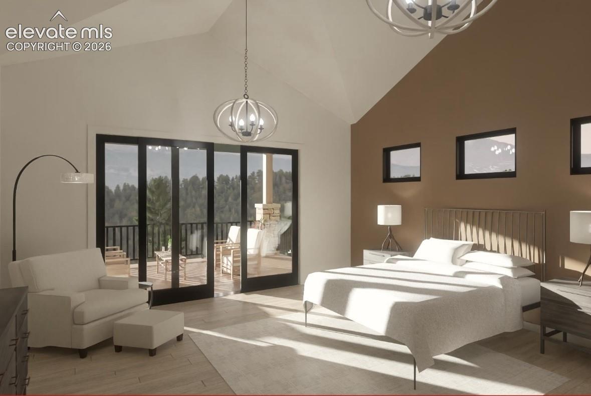 Vaulted ceiling with a contemporary chandelier, multiple windows, and a sliding glass door opening to a private balcony