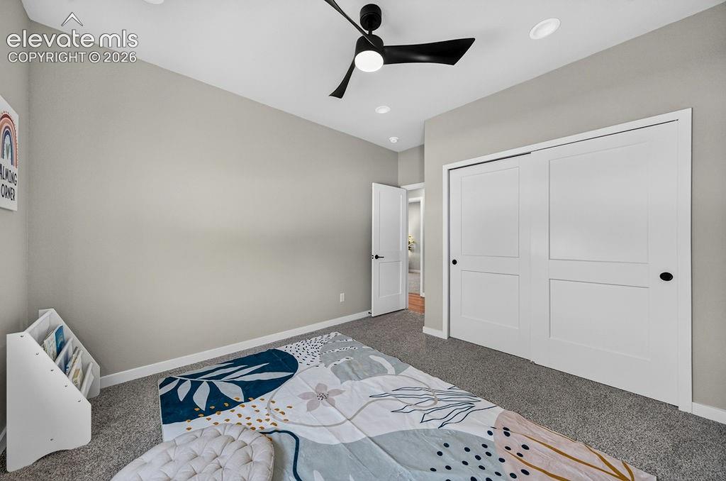 Room featuring neutral-toned walls, recessed lighting, and a contemporary black ceiling fan
