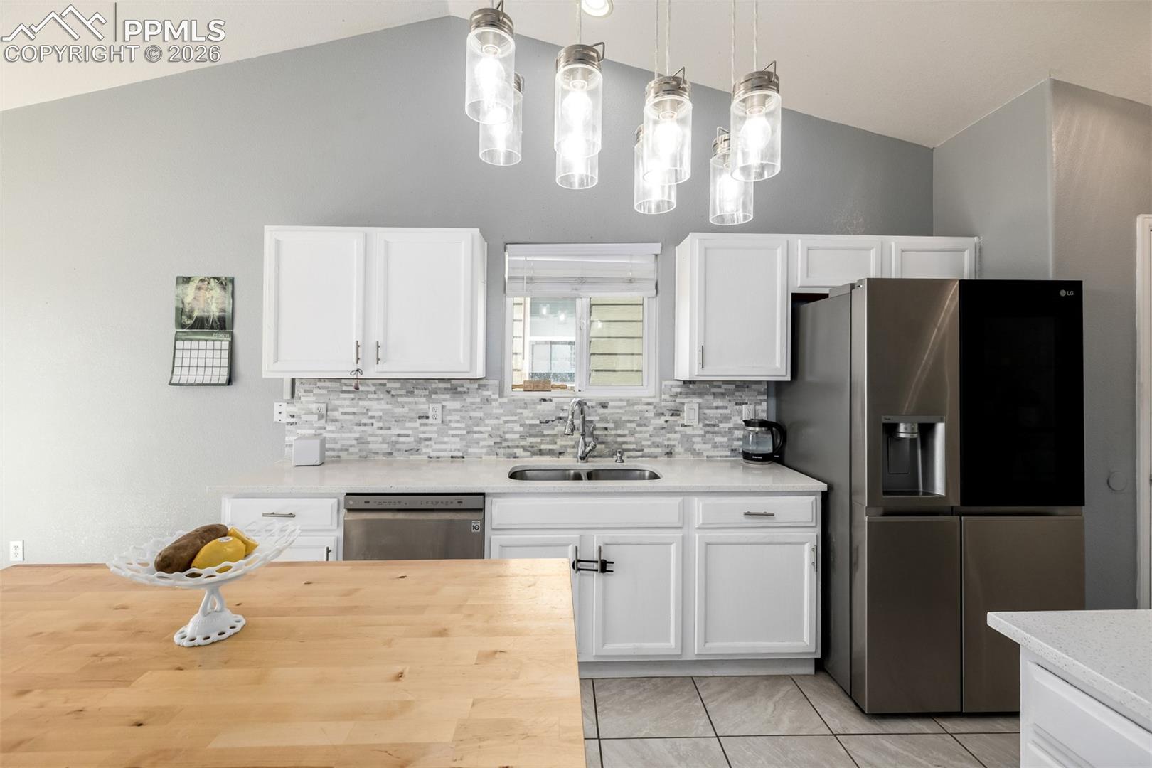 Updated Kitchen with beautiful white cabinetry and quartz/butcher block countertops