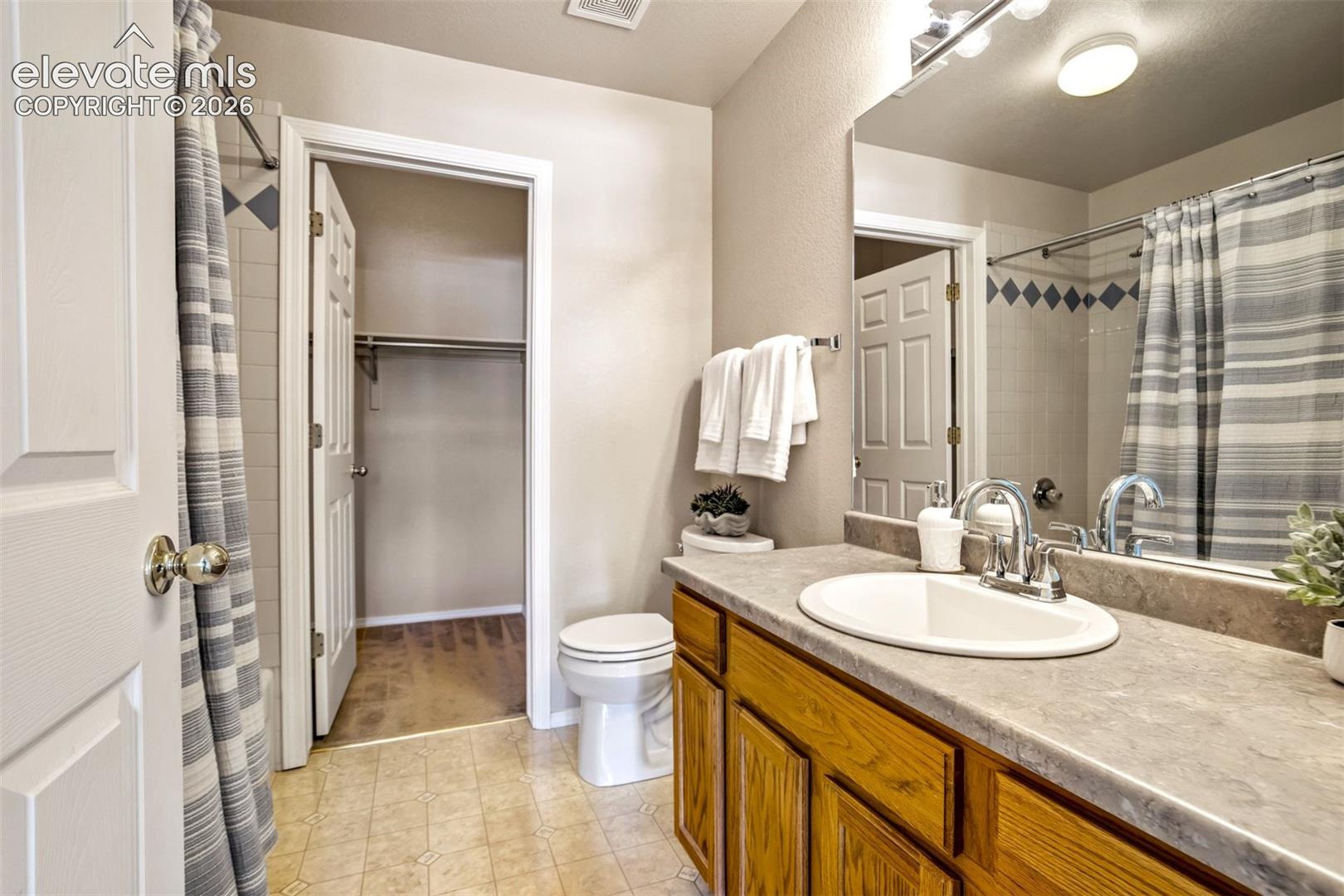 Full bathroom with tub/shower. Access to the walk-in closet