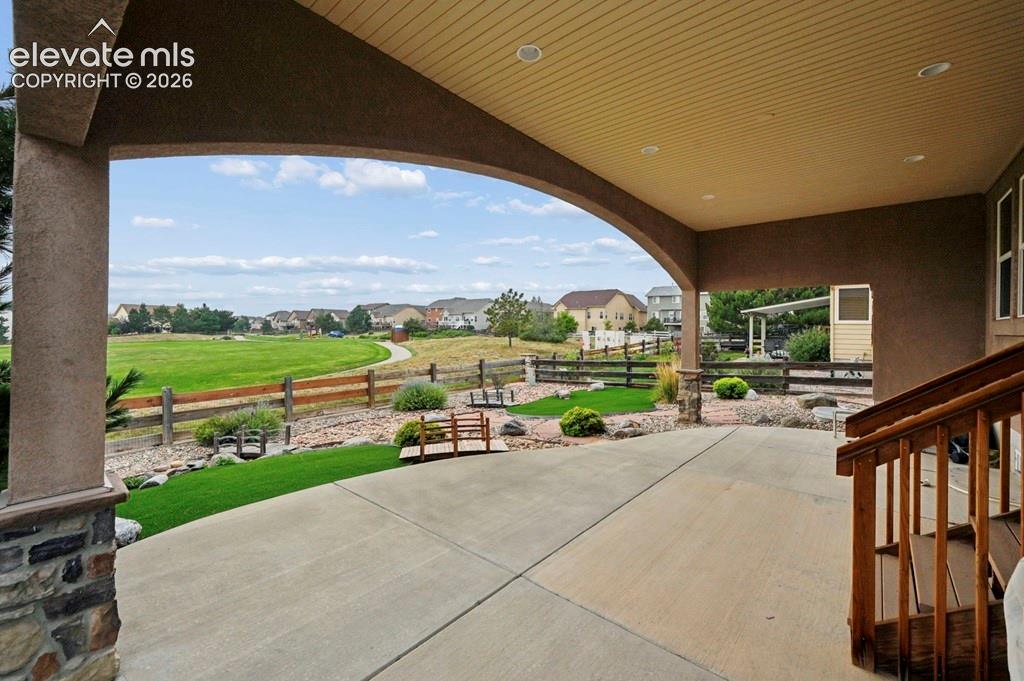 Covered patio, concrete, and stone-clad columns