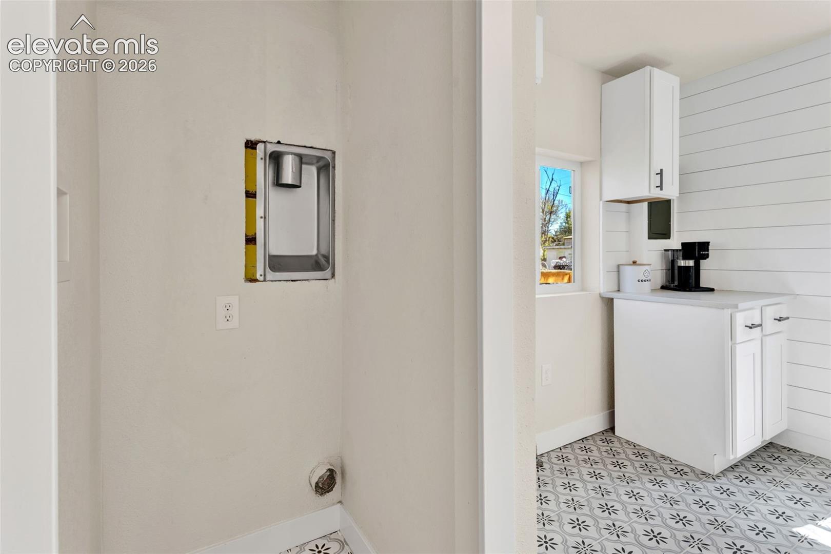 Dedicated laundry area featuring an electrical outlet and dryer vent