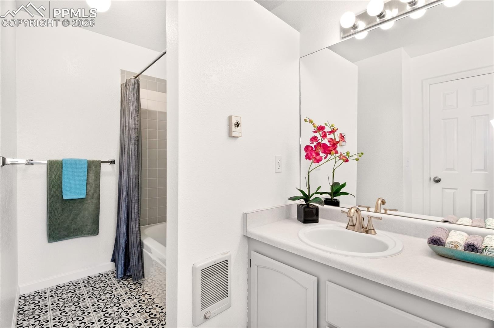 Primary ensuite with newly painted cabinets and new flooring.