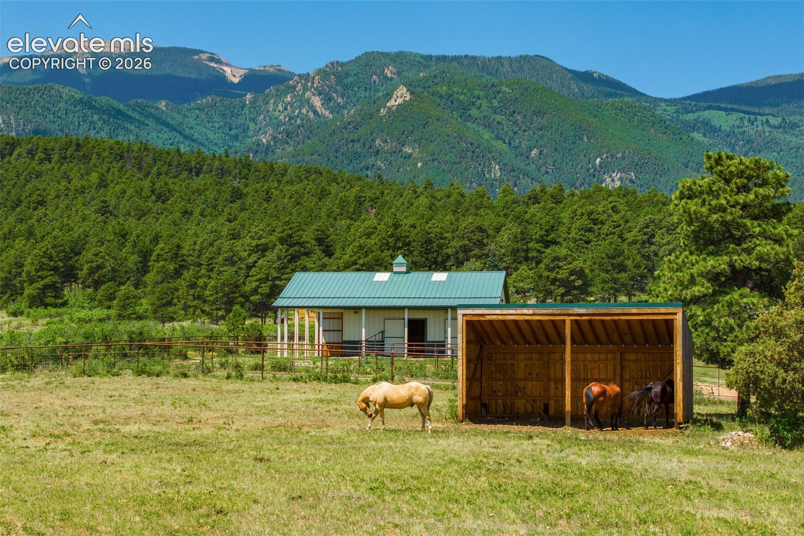 View of stable, turnout, and pasture photographed June 2026