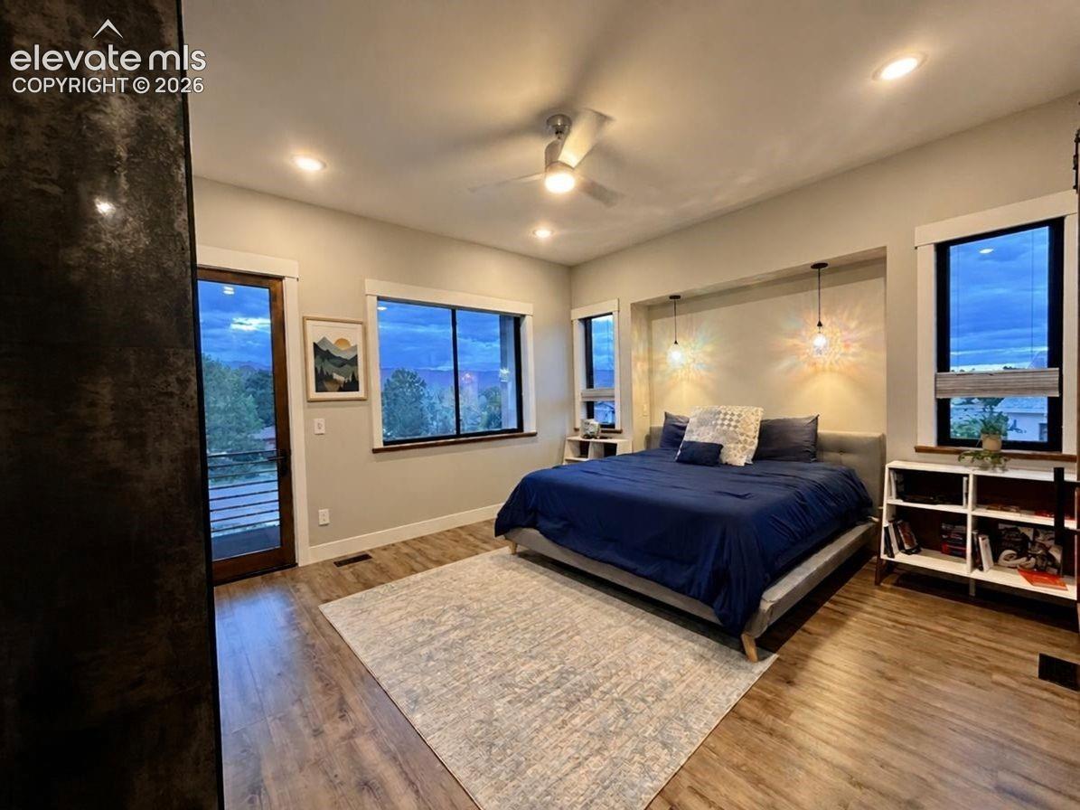 Wood-finish flooring, recessed lighting, and a ceiling fan