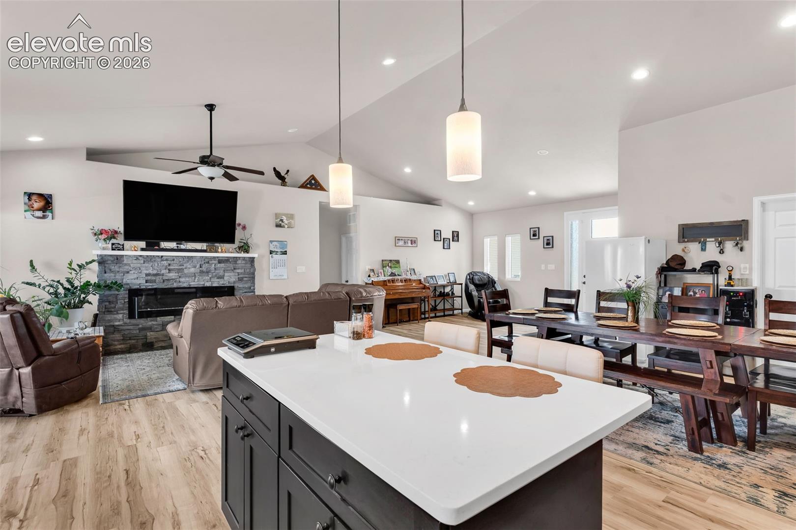 Spacious open-concept interior featuring light-toned walls and wood-finish flooring
