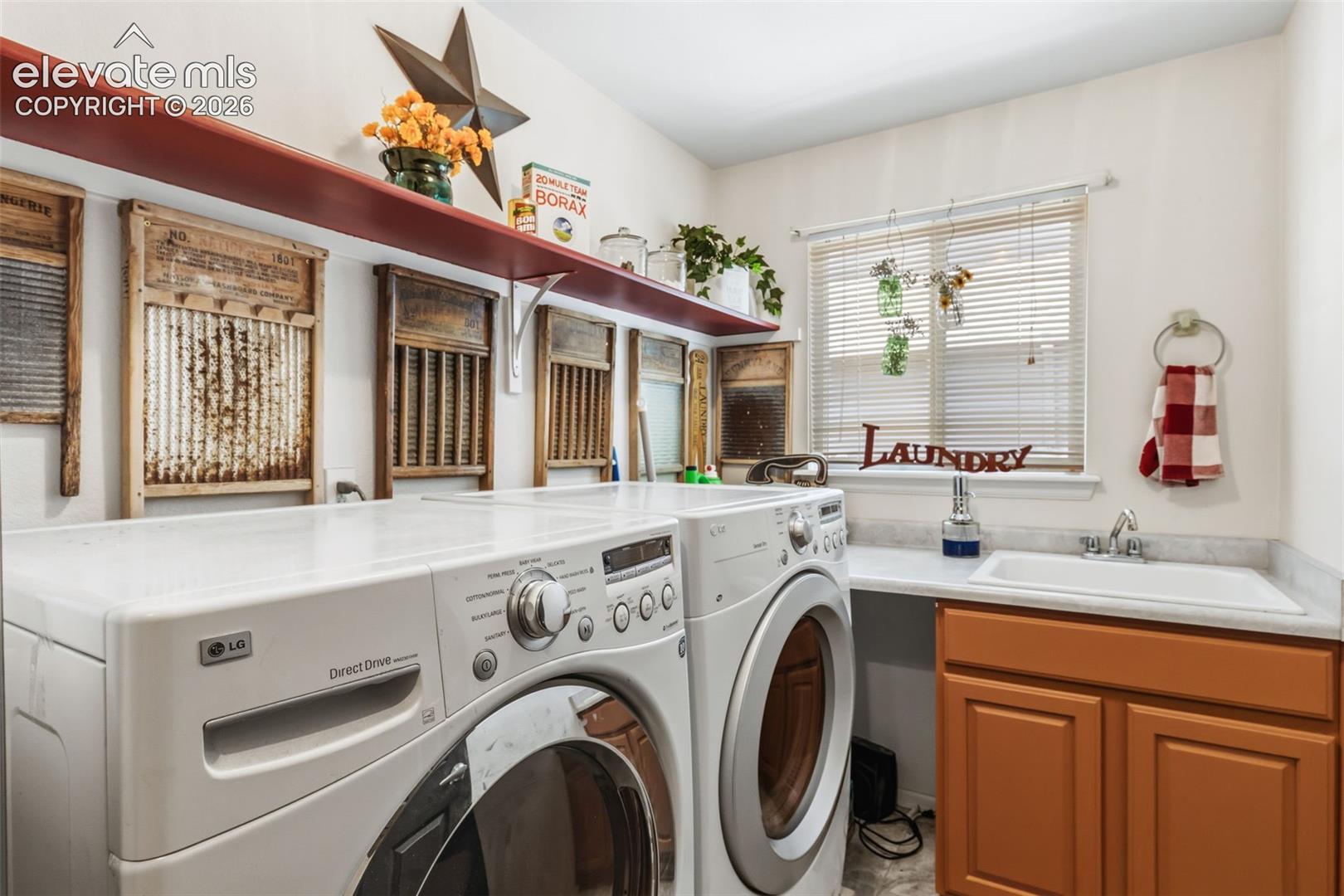 Main Level Laundry with Utility Sink, Cabinetry & Storage Space