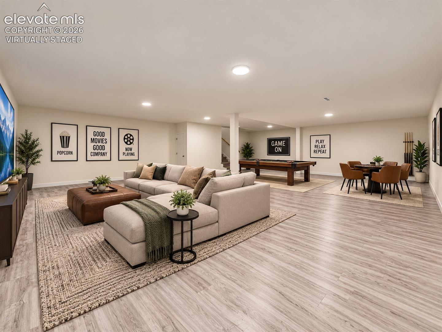 Virtually Staged Basement – Virtually staged to showcase the expansive lower level as a combination media, game, and recreation space while demonstrating the flexibility of the open floor plan. Virtually staged.