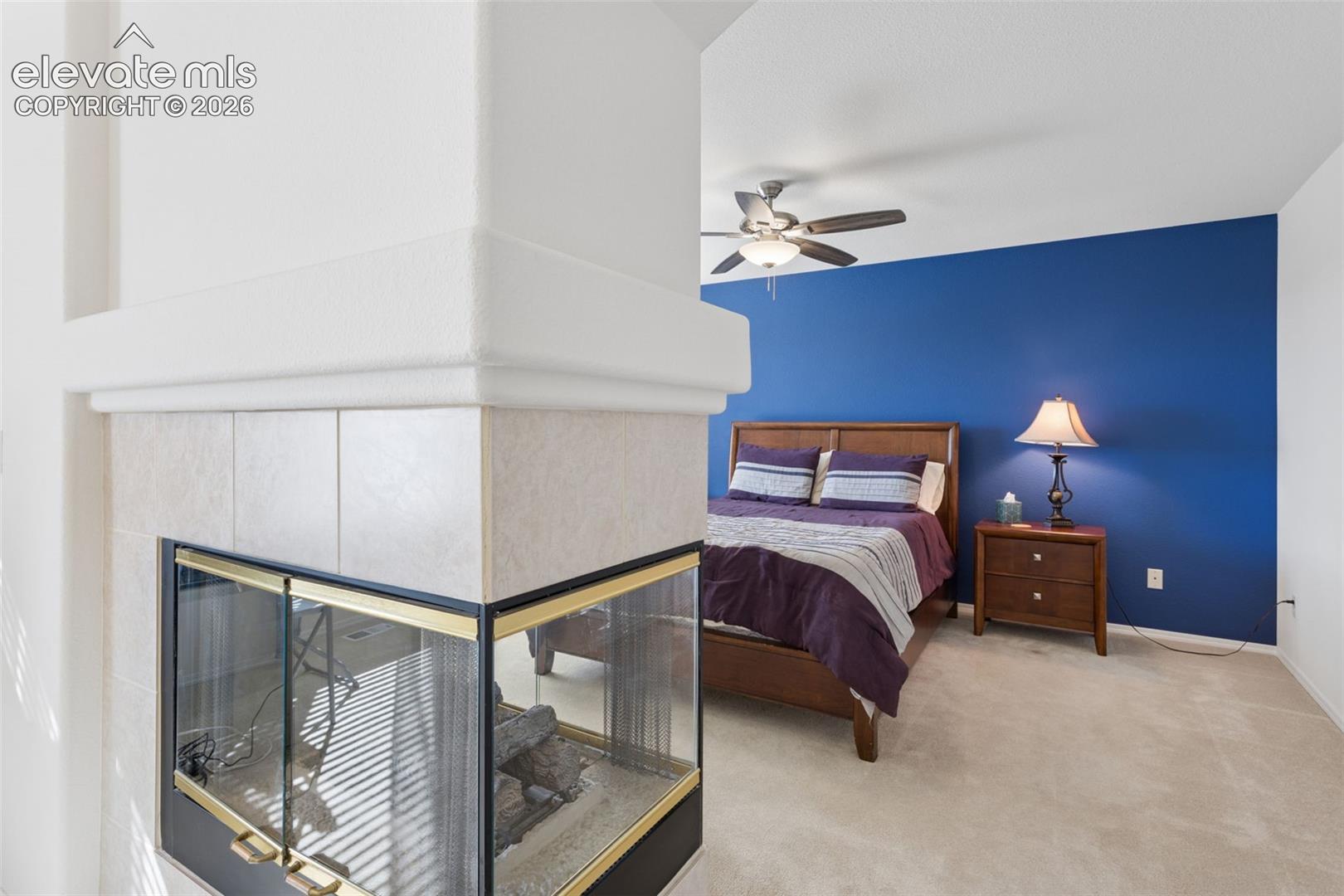 Double sided fireplace leading into primary bedroom suite