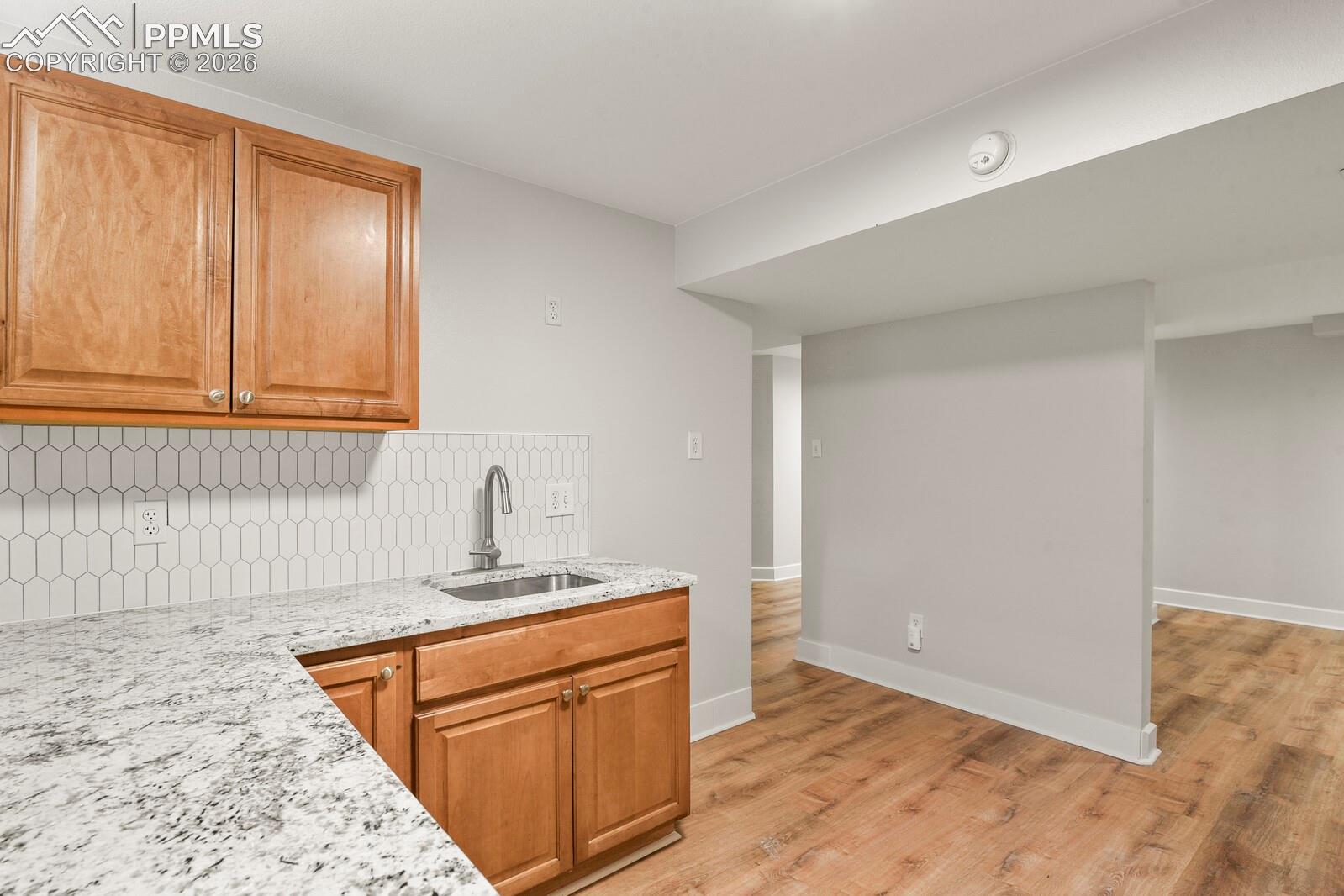 Kitchenette featuring LVP flooring, microwave, sink, dishwasher hook up as well as electrical for the stove, many cabinets and private entry from the backyard.