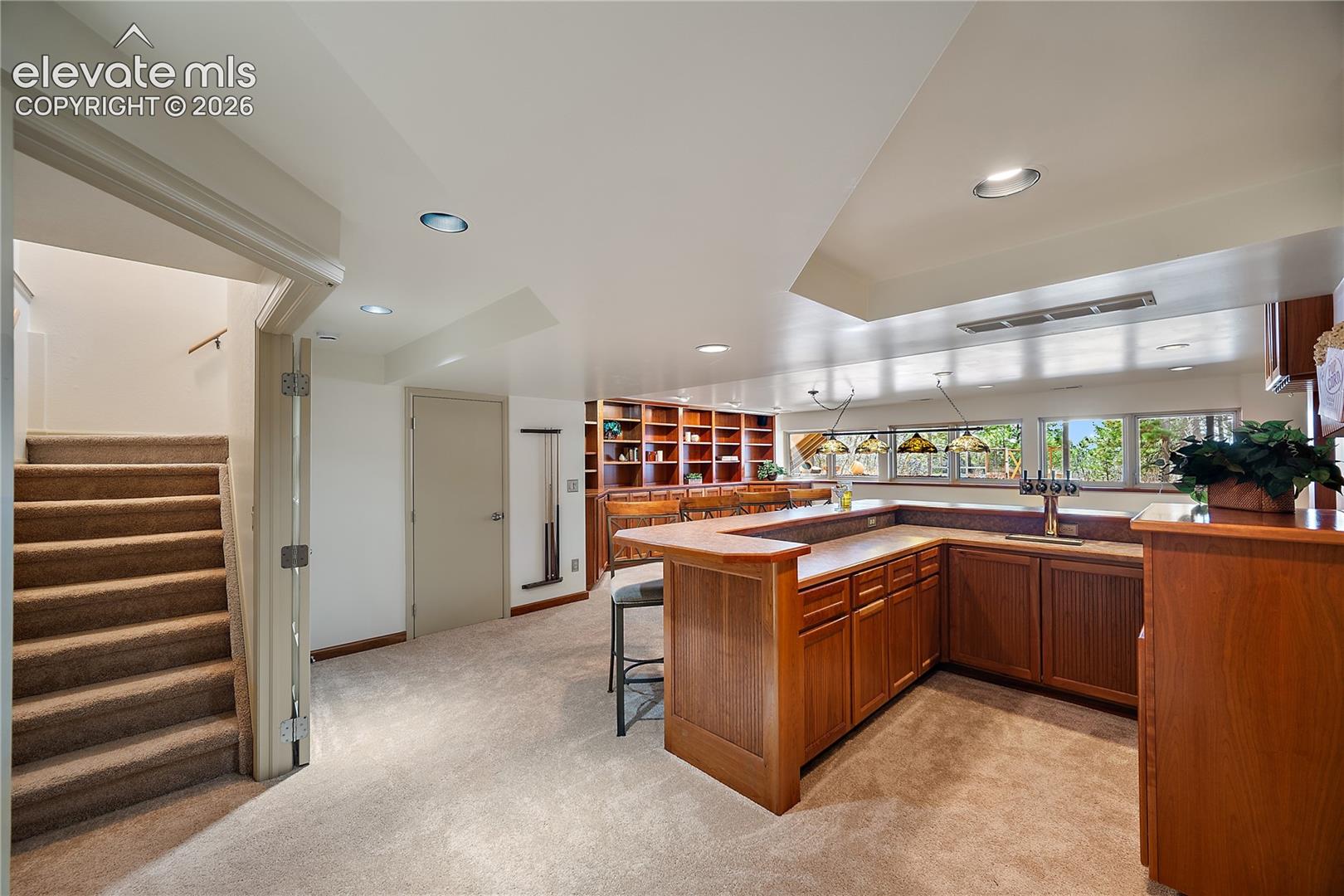 Wet bar with 4 beer taps, built in bookcase and tons of windows for natural light. 