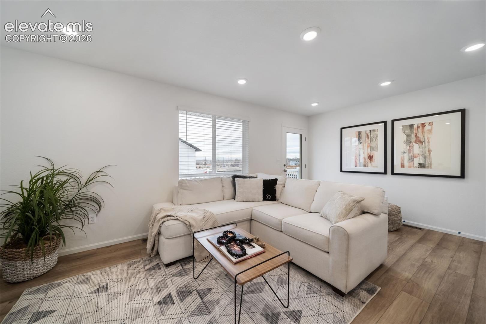 Recessed ceiling lighting, wood-finish flooring, multiple windows with blinds, and white walls
*photos of a model home*