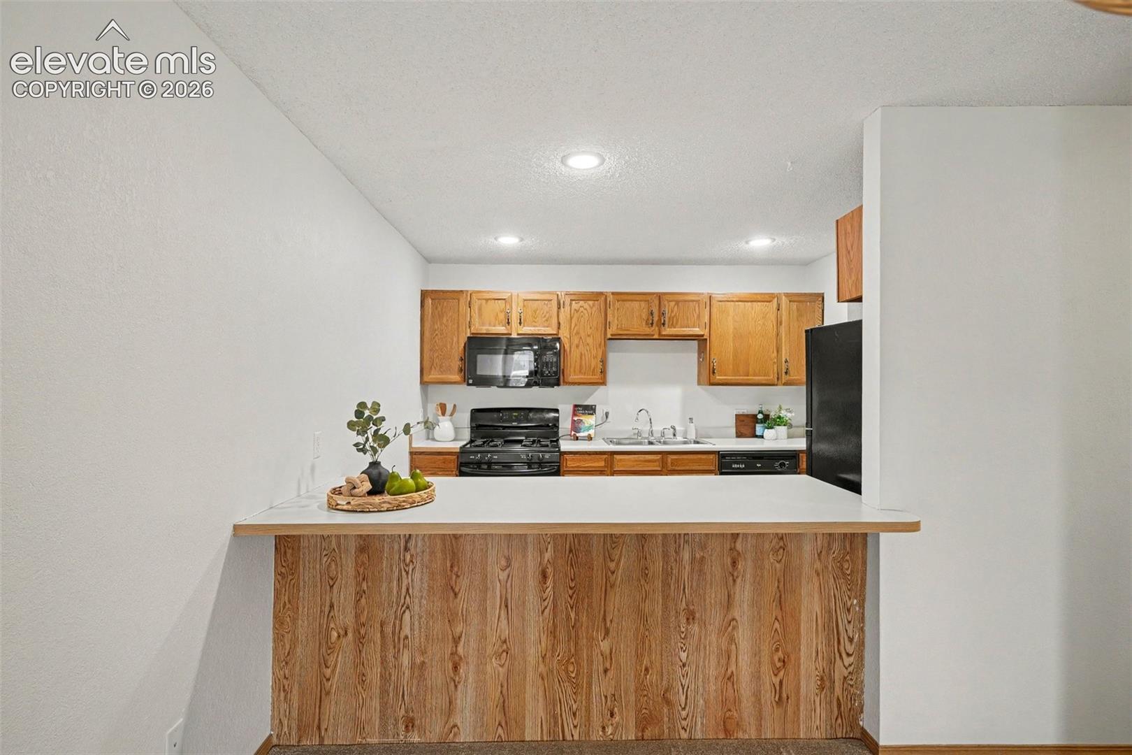 Breakfast bar, where kitchen opens to dining and living areas