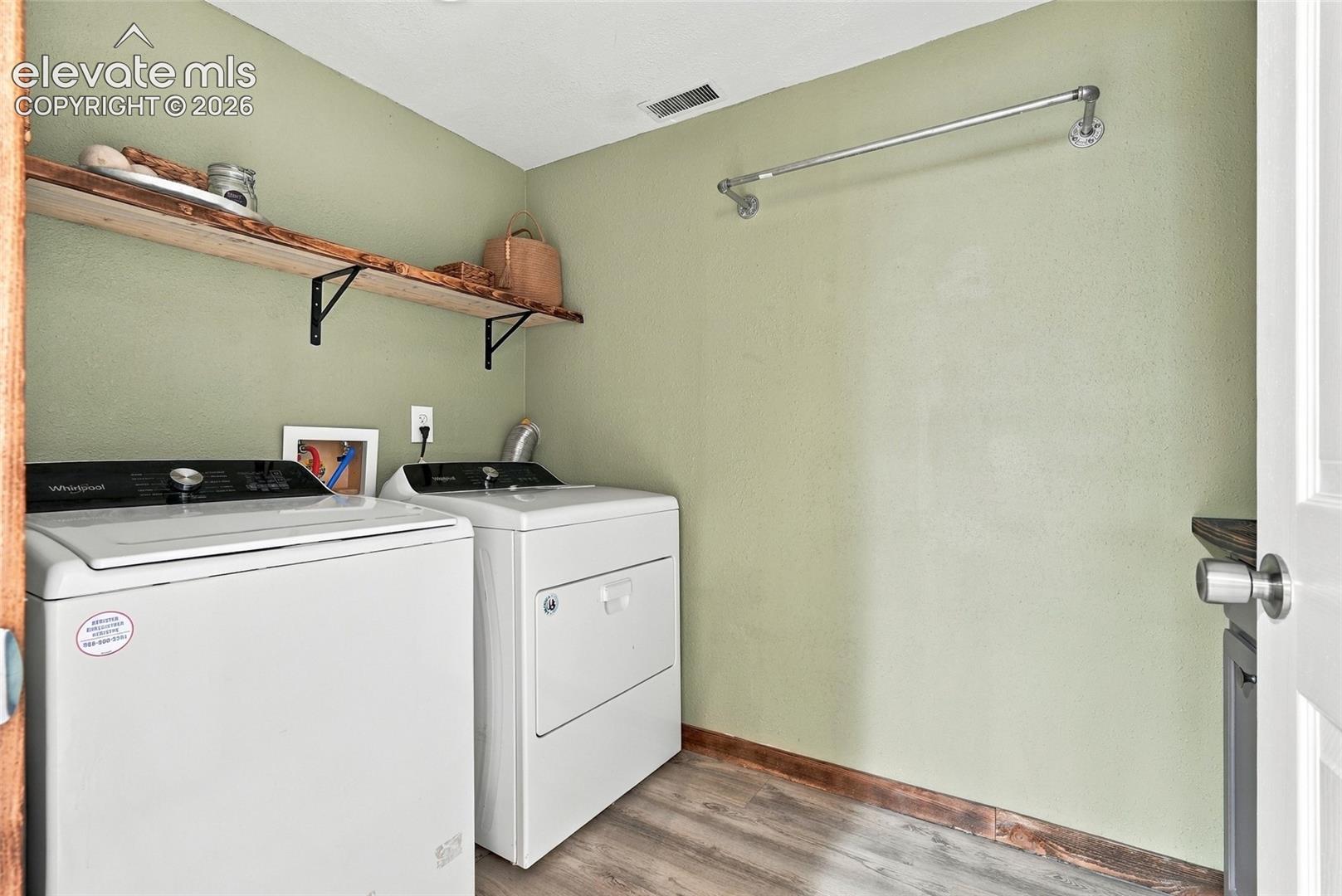 Light green walls complement wood-finish flooring