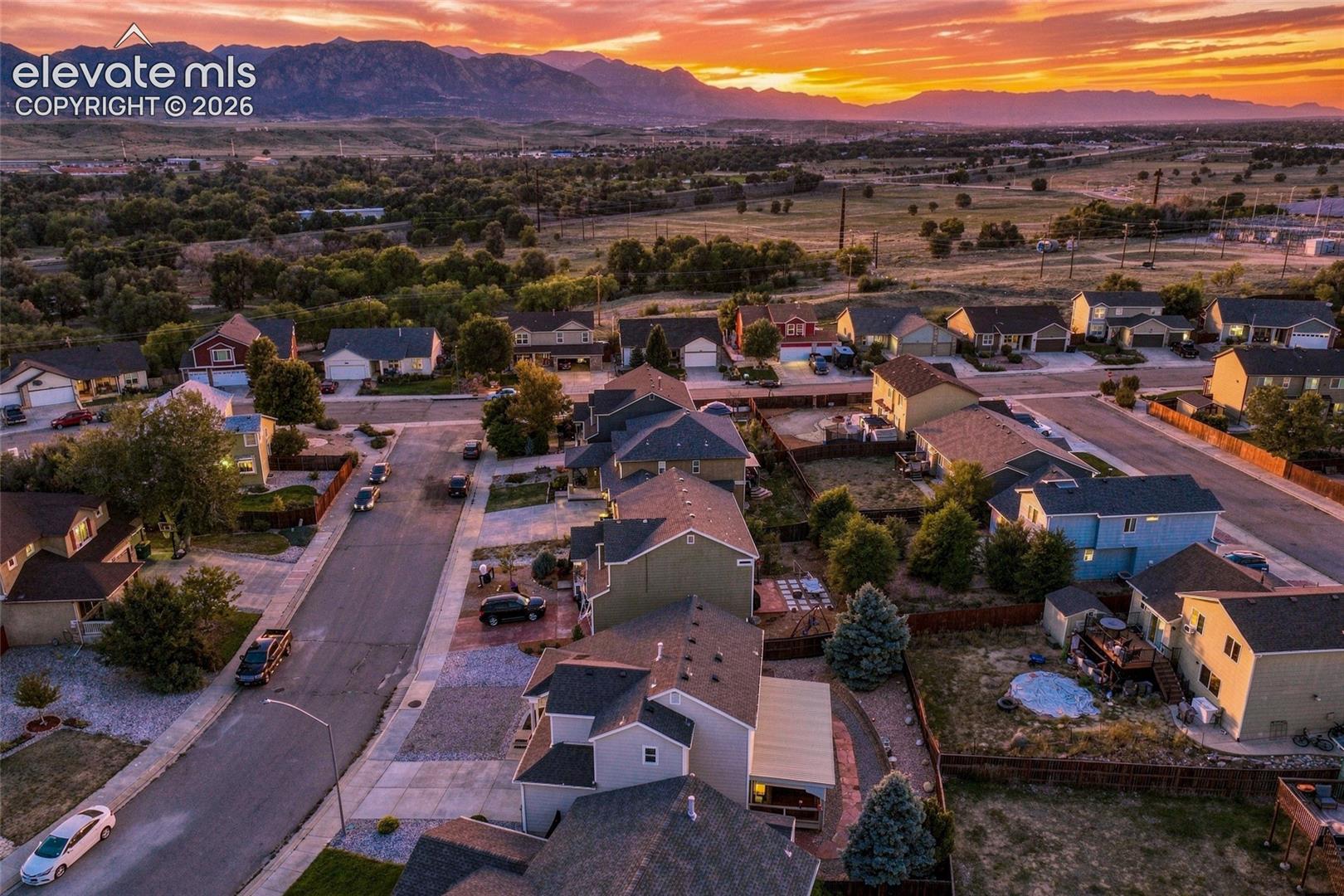 Established residential neighborhood with a mountain backdrop, mature trees, and paved streets