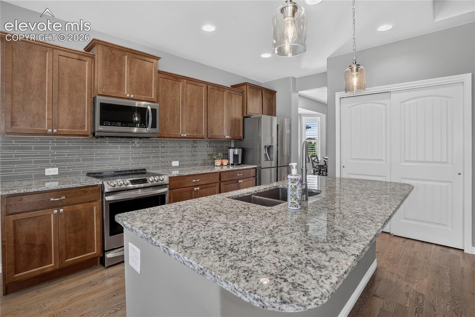 Kitchen features an island & granite counters