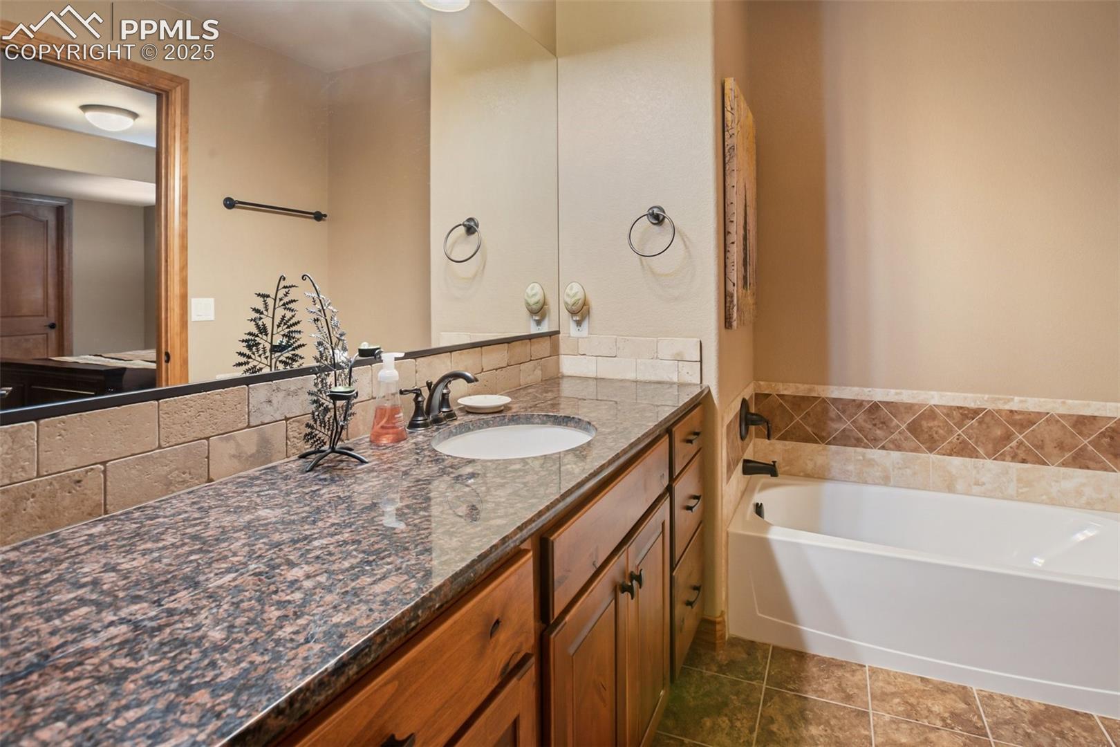 Full bathroom in lower level connected to back lower bedroom
