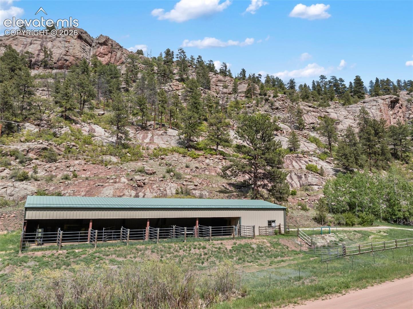 Barn with horse stalls, drive thru, workshop and tack room.
