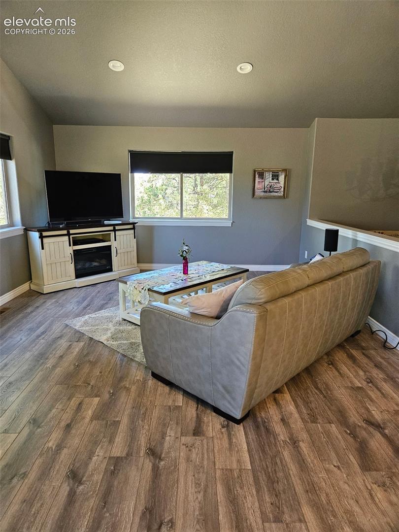 Open concept to dining and kitchen. Vaulted ceilings